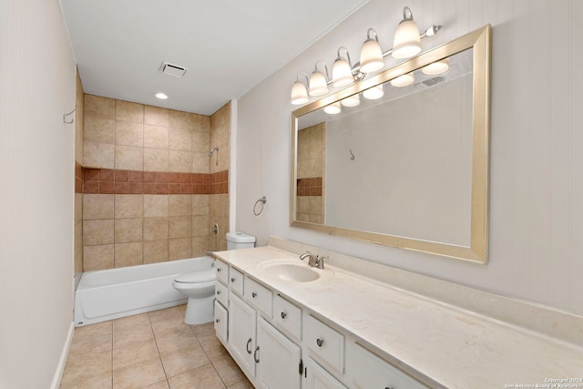 full bathroom featuring tile patterned floors, tiled shower / bath, vanity, and toilet