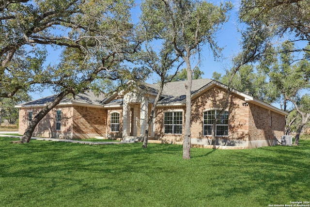 single story home featuring central AC and a front yard