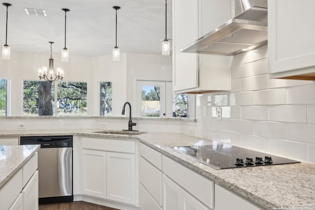 kitchen with dishwasher, pendant lighting, wall chimney exhaust hood, and sink