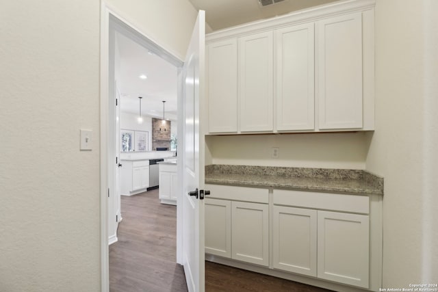 kitchen featuring dishwasher, light stone countertops, white cabinetry, and dark wood-type flooring