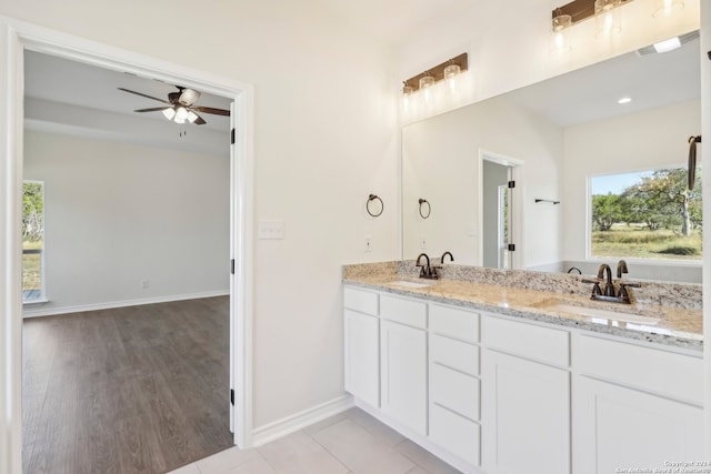 bathroom featuring wood-type flooring, vanity, and ceiling fan