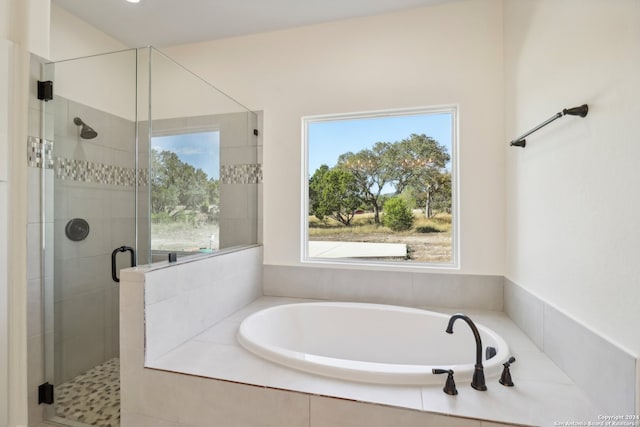 bathroom featuring separate shower and tub