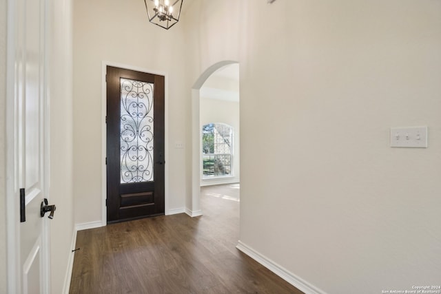 entrance foyer featuring dark hardwood / wood-style floors and an inviting chandelier