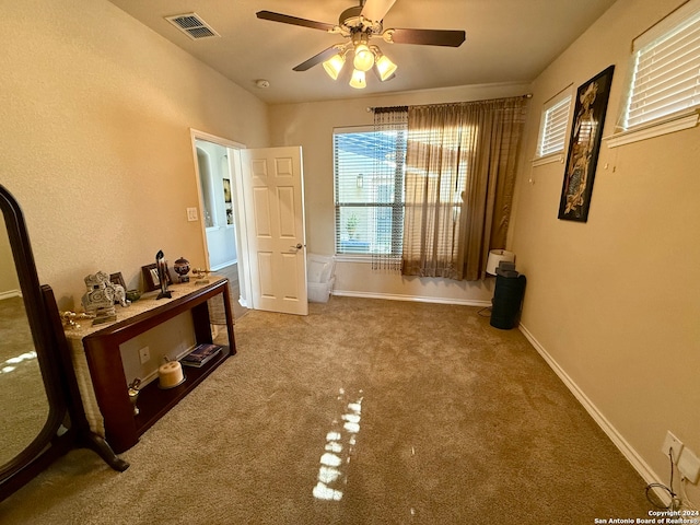 interior space featuring carpet flooring and ceiling fan