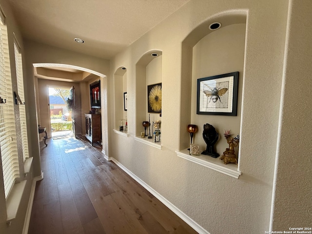 hall with hardwood / wood-style flooring