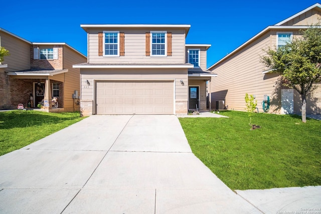 view of front of property with a garage, a front yard, and central AC