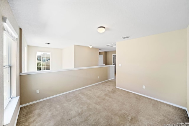 unfurnished room with light colored carpet