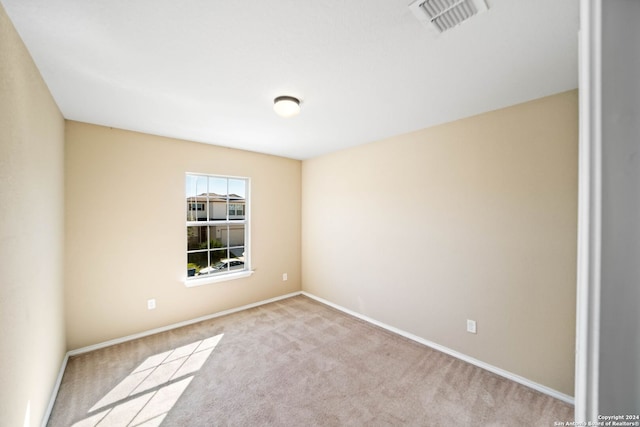 spare room with light colored carpet