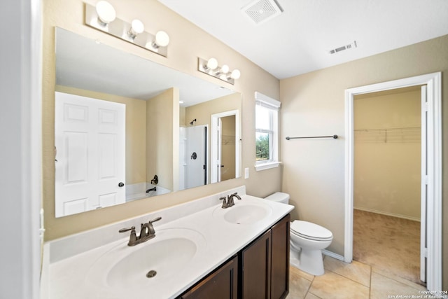 bathroom with tile patterned flooring, toilet, a shower, and vanity