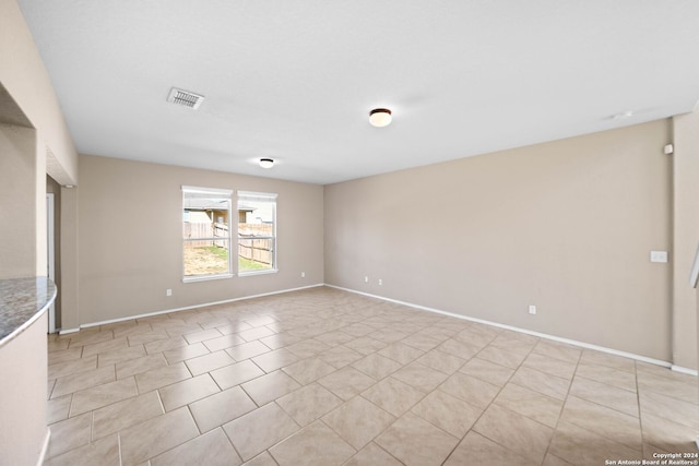 unfurnished room featuring light tile patterned floors