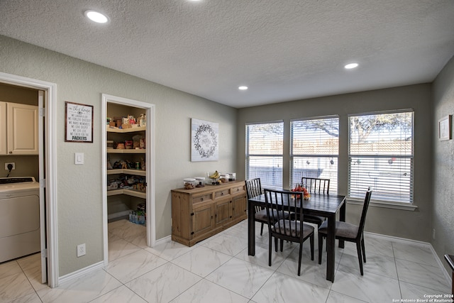 dining room with washer / dryer and a textured ceiling