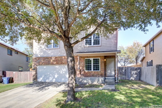 view of front of property with a front yard and a garage