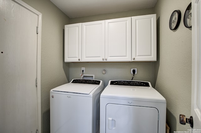 laundry area with cabinets and washing machine and clothes dryer