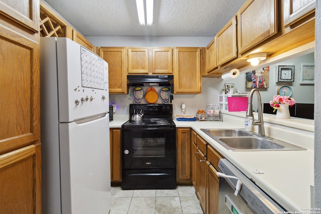 kitchen featuring a textured ceiling, white appliances, light tile patterned floors, and sink