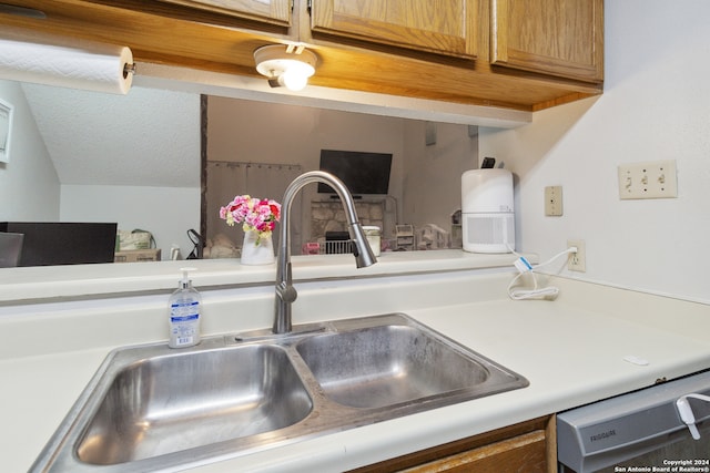 kitchen featuring dishwashing machine and sink