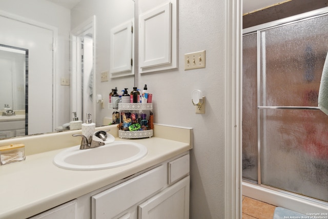 bathroom with vanity, tile patterned floors, and walk in shower