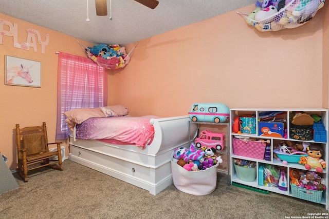 bedroom featuring carpet, ceiling fan, and a textured ceiling