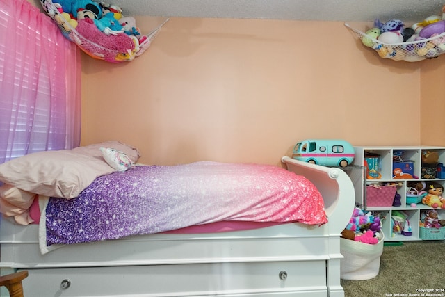 carpeted bedroom featuring a textured ceiling