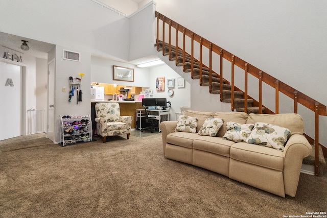 living room featuring carpet and a high ceiling