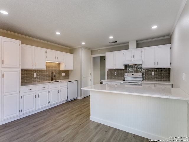 kitchen with white appliances, white cabinets, sink, crown molding, and light hardwood / wood-style flooring