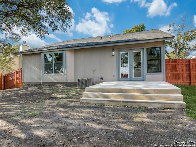 back of house featuring central AC unit and a wooden deck