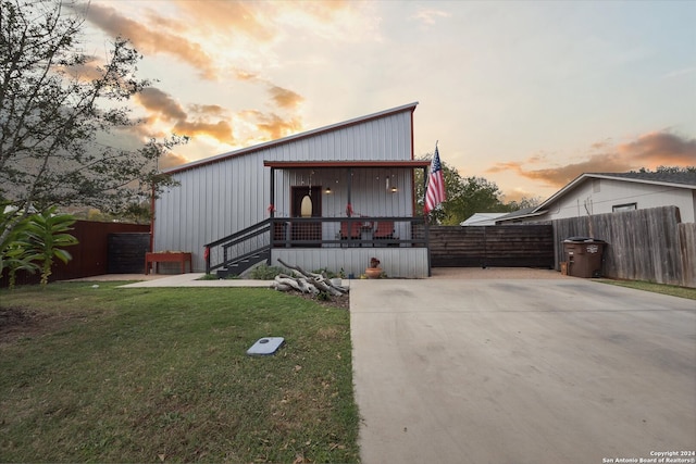 view of front of home with a yard and a porch