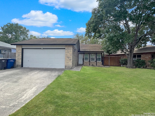 ranch-style house with a garage and a front yard