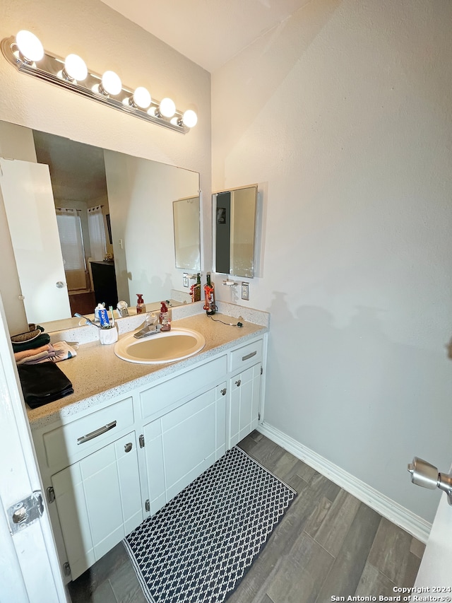 bathroom featuring vanity and hardwood / wood-style flooring