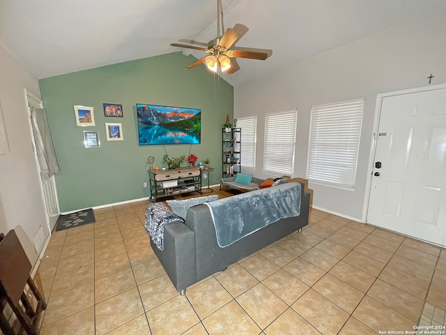 living room with ceiling fan, lofted ceiling, and light tile patterned floors