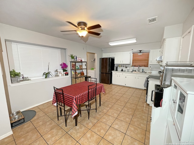 kitchen with white cabinetry, ceiling fan, sink, decorative backsplash, and black refrigerator