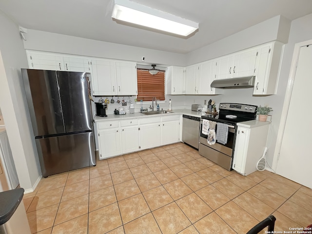 kitchen featuring sink, stainless steel appliances, tasteful backsplash, white cabinets, and light tile patterned flooring