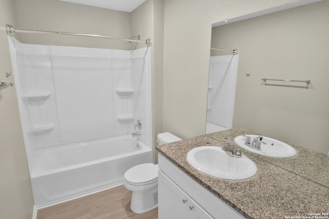 full bathroom featuring hardwood / wood-style floors, vanity, toilet, and shower / tub combination