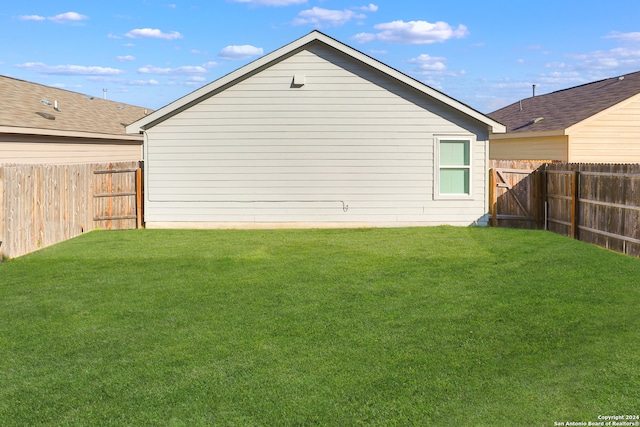 rear view of property with a lawn