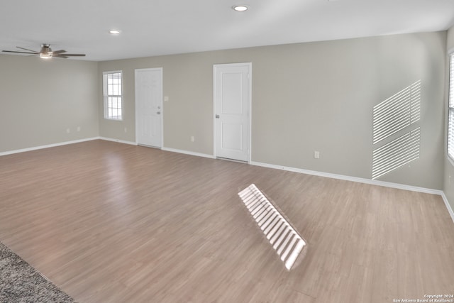 spare room featuring light hardwood / wood-style flooring and ceiling fan