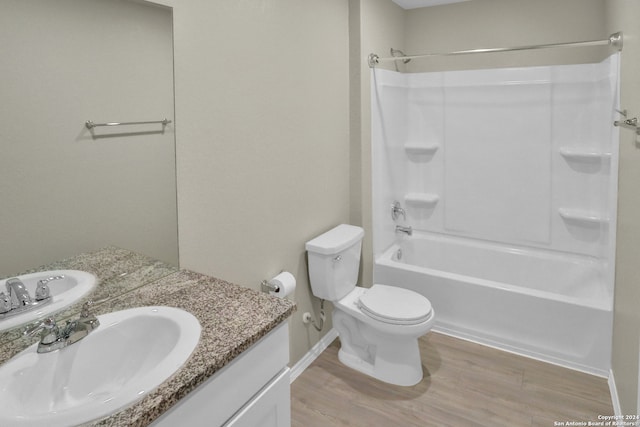 full bathroom with washtub / shower combination, toilet, vanity, and hardwood / wood-style flooring