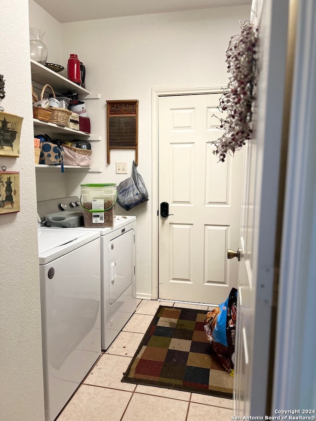 laundry area featuring washer and dryer and light tile patterned floors