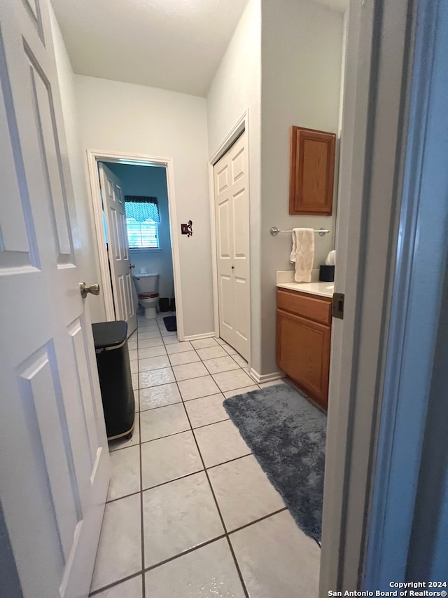 bathroom with toilet and tile patterned floors