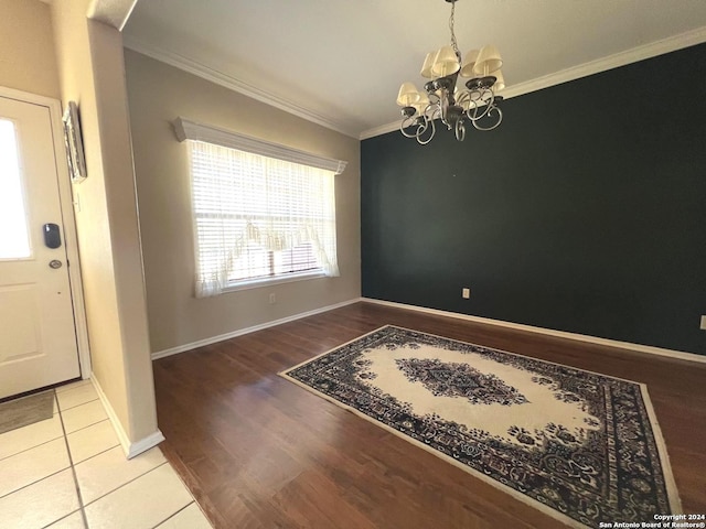 interior space featuring crown molding, light wood-type flooring, and an inviting chandelier