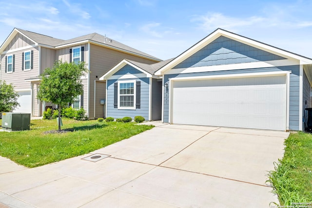 view of front of home featuring a front yard and a garage