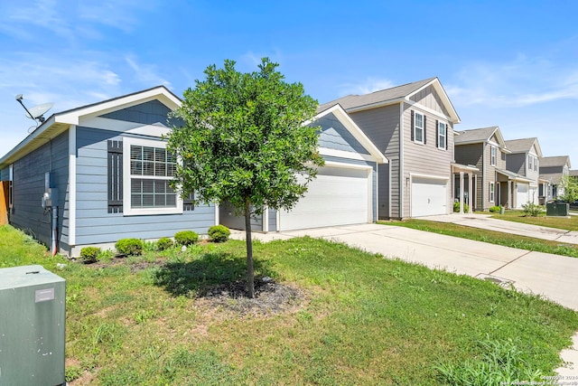 view of front of property featuring a front yard and a garage