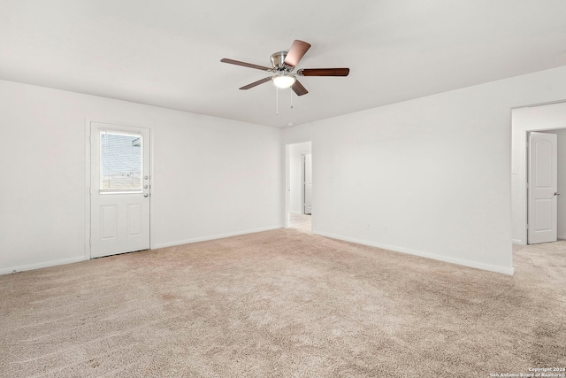 spare room featuring ceiling fan and light carpet