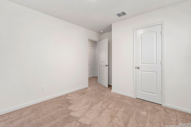 unfurnished bedroom with light carpet