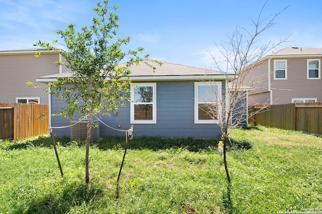 rear view of house featuring a lawn