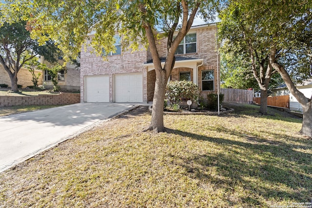 front facade featuring a garage and a front lawn