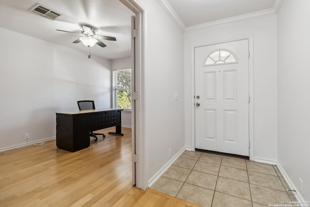 entrance foyer with ceiling fan, light hardwood / wood-style flooring, and ornamental molding