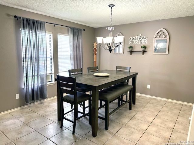 9830 Lauren Mist, San Antonio, TX 78251 - dining area featuring a textured ceiling, a chandelier, light tile patterned floors, and baseboards