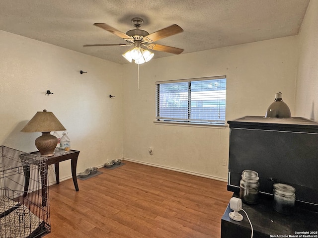 9830 Lauren Mist, San Antonio, TX 78251 - misc room featuring wood finished floors, a ceiling fan, a textured ceiling, and baseboards