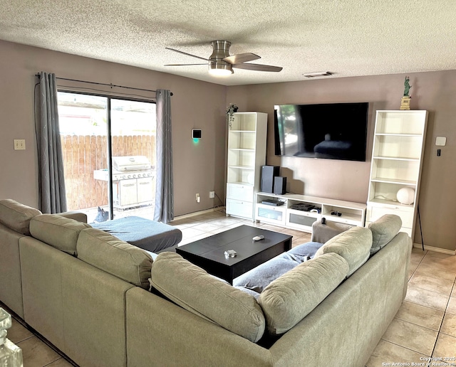 9830 Lauren Mist, San Antonio, TX 78251 - living room with ceiling fan, light tile patterned flooring, a textured ceiling, and baseboards