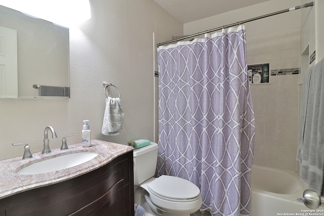 full bathroom featuring shower / bath combo, vanity, and toilet