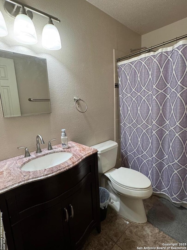 9830 Lauren Mist, San Antonio, TX 78251 - bathroom featuring vanity, toilet, a textured ceiling, a shower with shower curtain, and a textured wall